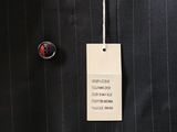 a picture of a black pinstripe suit with a tag attached to it