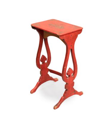 a small red table with a red top on a white background