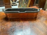 a large metal pan sitting on a wooden table