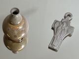 a small silver object next to a small silver object on a table