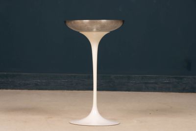 a small white table with a gold rim on it