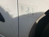 a white car with a sticker on the side of it