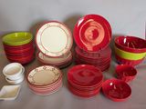 many red and green plates and bowls on the table
