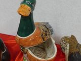 many different types of ducks on a red cloth