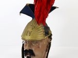 a head of a man wearing a helmet with a red feather on it