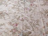 a bed with a floral comforter on top of it