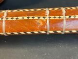 a wooden stick with a pattern on it sitting on a table