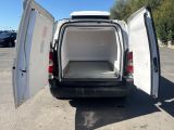 a white van with its doors open in a parking lot