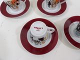 four cups and saucers with designs on them on a table