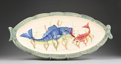 a fish shaped dish with a fish and a fish on it