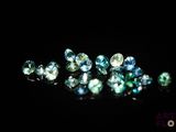 a close up of a bunch of diamonds on a black surface