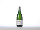 a bottle of white wine sitting on a table