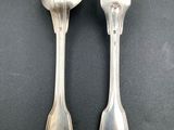 pair of silver plated spoons and a fork on a black surface
