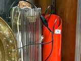 a red fire extinguisor sitting on a shelf next to a gold plate
