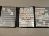 three folders with stamps are lined up on a table