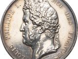 une vieille pièce d'argent sur laquelle figure le portrait d'un homme