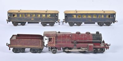 three toy trains sitting next to each other on a white surface