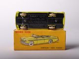 a yellow toy car sitting on top of a yellow box