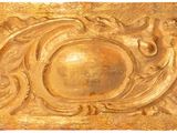 a close up of a gold plate on a white background