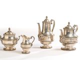 three silver teapots and two coffee pots sitting next to each other