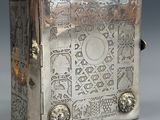 an old silver box with a decorative design on the front