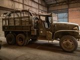 a military truck that is parked in a garage