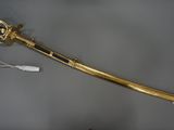 an old gold sword with a white handle and a black handle
