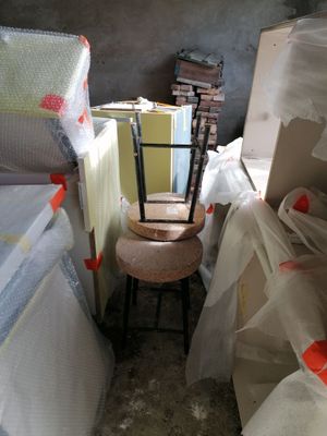 a chair that is sitting on a stool in the middle of a room
