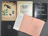three books are sitting on a table next to each other