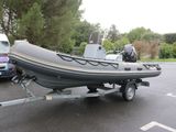 a small boat on a trailer in a parking lot