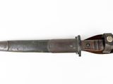 an old knife with a wooden handle on a white surface
