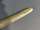 a gold colored baseball bat sitting on a table
