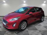 a red ford fiesta parked on a checkered tile floor