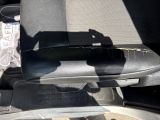 a black seat in the back of a car with a cell phone in it
