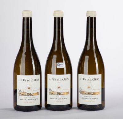 three bottles of wine sitting next to each other on a table