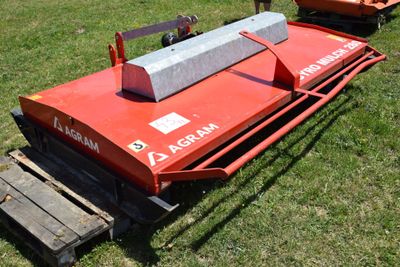 a red machine that is sitting in the grass