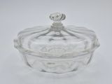 a clear glass bowl with a lid on a white surface