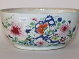 un bol blanc orné d'un motif floral bleu et rouge