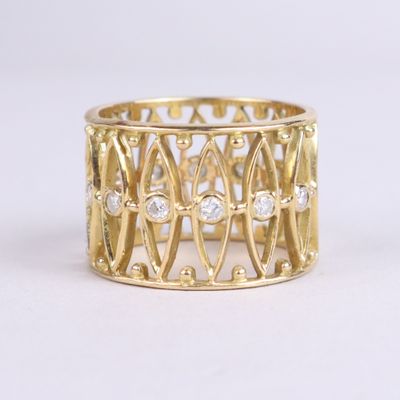 a close up of a gold ring with diamonds on a white background
