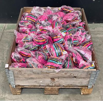 a wooden crate filled with lots of pink and blue lollipops