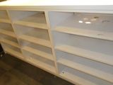 a white shelf with shelves on it in a room
