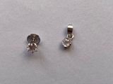 pair of diamond earrings on a white surface