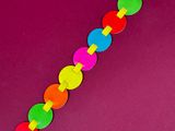 a close up of a colorful bracelet on a purple surface