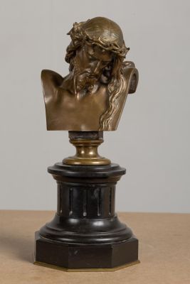 a bronze bust of a man sitting on a table