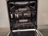 a dishwasher that is sitting in the middle of a kitchen