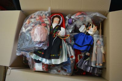 many dolls in a box that are in a box