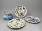 three plates and a bowl are sitting on a table