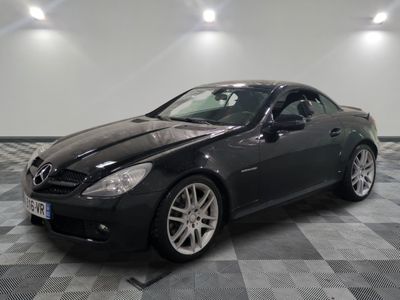 a picture of a black mercedes slk parked in a garage