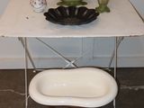 a small table with a bowl and a bowl on it