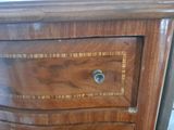 a close up of a wooden dresser with a drawer